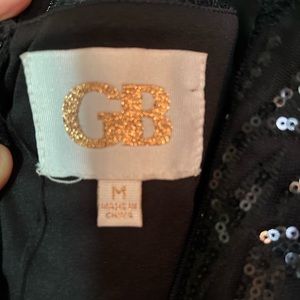 Black sequin GB cocktail dress bottom lined in feathers.